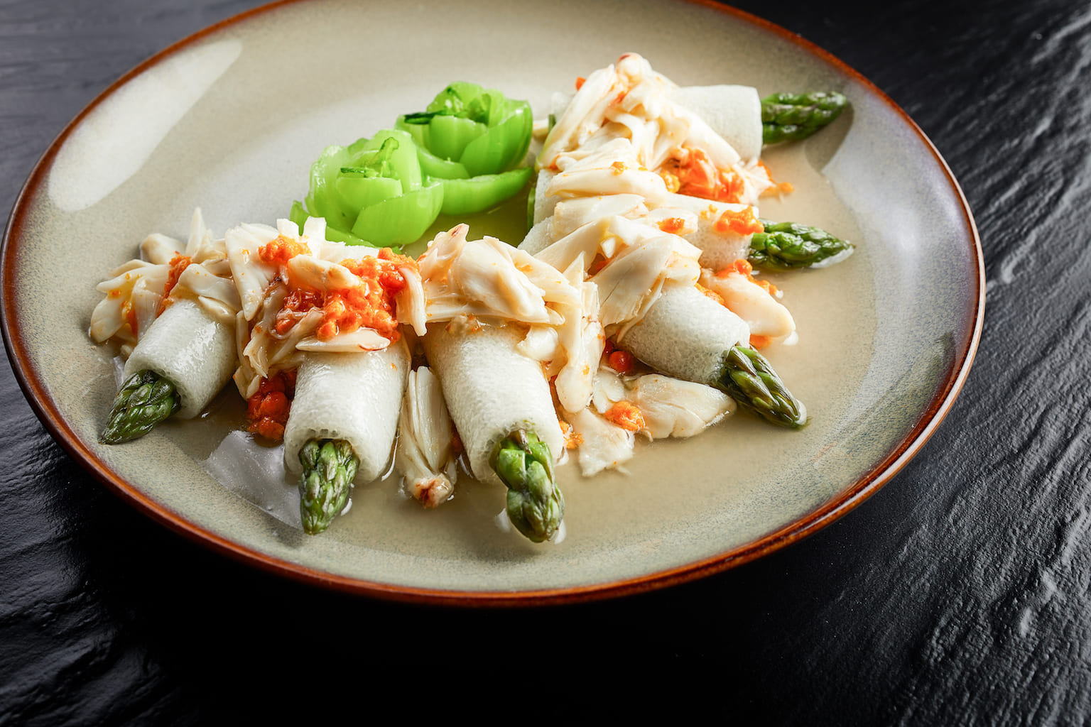 Braised asparagus and bamboo shoot topped with crab meat and crab roe
